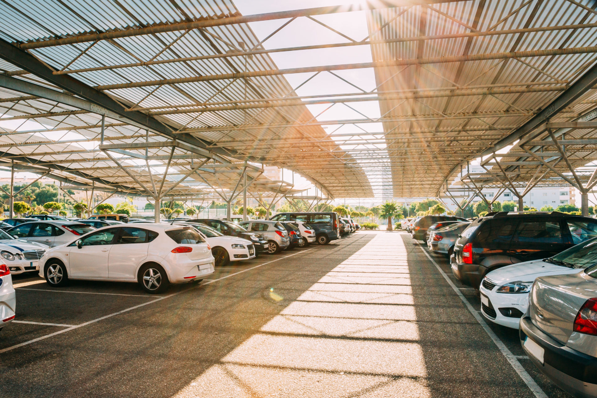 cars on a covered parking lot in sunny summer day 2021 09 04 11 59 29 utc scaled