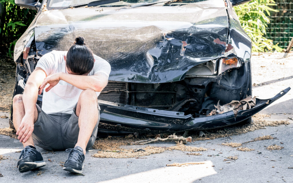 man crying on his old damaged car after crash acci 2022 12 09 04 45 17 utc scaled